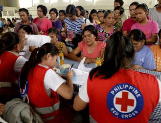 Red Cross volunteers register residents affected by flood caused by Typhoon Koppu, Philippines