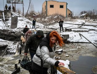 Civilians cross a river on a blown up bridge on Kyiv's northern front on March 1, 2022