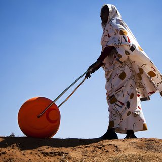 A woman in El Fasher, North Darfur, uses a Water Roller for easily and efficiently carrying water.